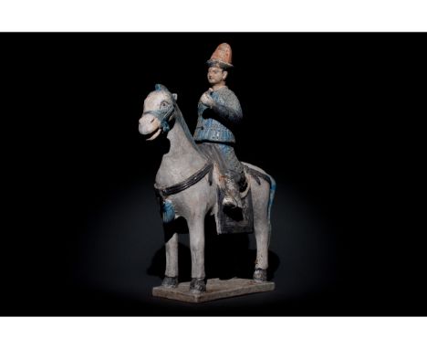 Ca. 1368-1644 AD. Ming Dynasty. Ceramic Horse with Rider. An elegant ceramic figurine depicting a grey horse in a standing po