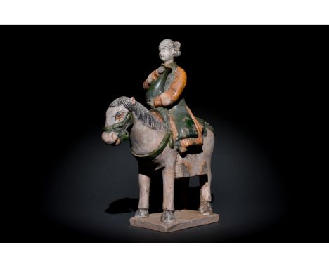 Ca. 1368-1644 AD. Ming Dynasty. Ceramic Horse with Rider. An elegant ceramic figurine depicting a grey horse in a standing po