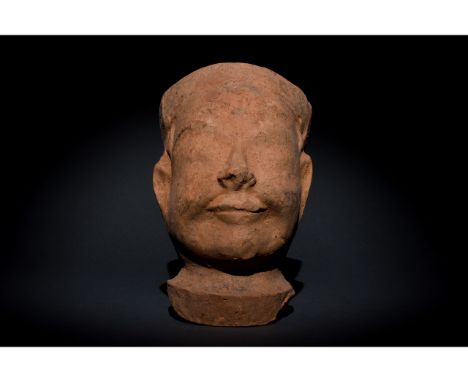 C. AD 618-907. Tang Dynasty. A terracotta head of a court employee with a calm expression denoted by a prominent nose, round 