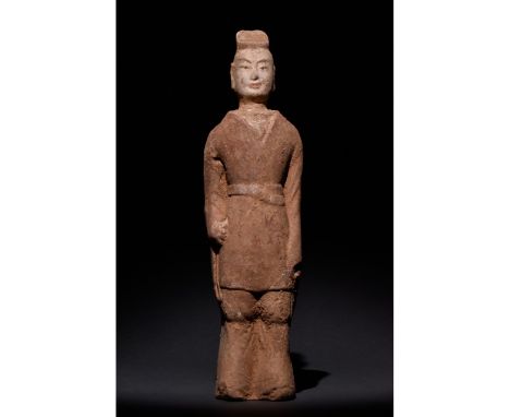 C. 500 AD. Chinese Northern Wei Dynasty. A carefully crafted male attendant figure wearing in a brown tunic and trousers; a c