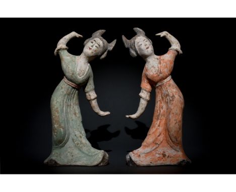 C. AD 618 and 907. Tang Dynasty. A delicate Tang Dynasty pair of female dancer figures. Both wearing long flowing gowns with 