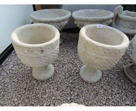 2 stone Mayan style urns decorated with Aztec design on circular base