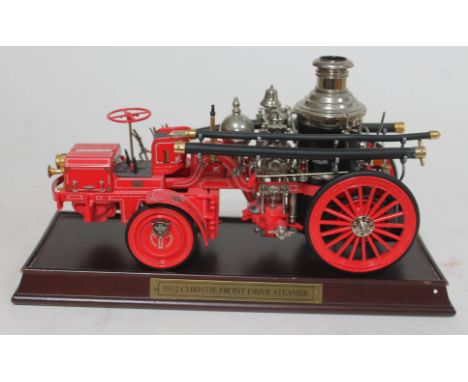 A Franklin Mint 1912 Christie Front Drive Steamer fire engine model on wooden plinth.&nbsp;Condition - front left head light 