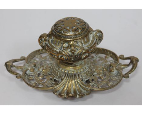 A 19th century cast brass inkwell of pierced scroll form, length 22cm. 