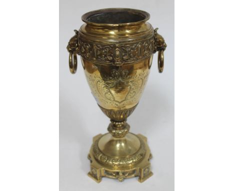 A Victorian brass oil lamp base with armorial decoration, the weight base stmap 'W&amp;W', height 33cm. 