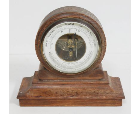 An oak framed aneroid barometer. 