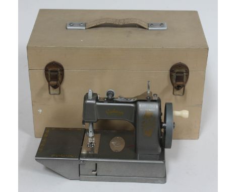 A child's vintage Vulcan sewing machine in wooden case. 