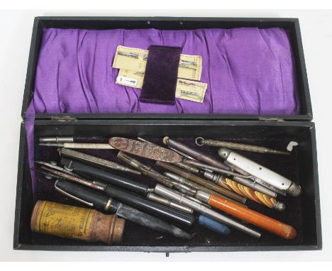 A case containing various penknives, propelling pencils and a fountain pen, button hooks etc. 