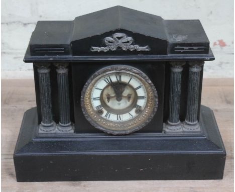 A late Victorian black slate architectural mantel clock with visible Brocot type escapement, length 38cm. 