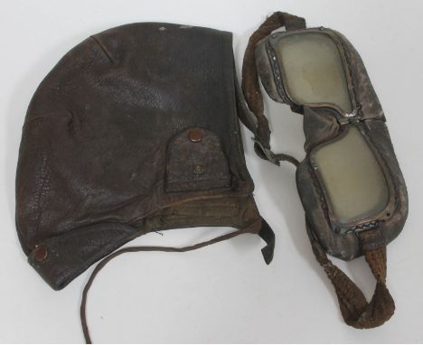 A vintage leather flying helmet and goggles. 