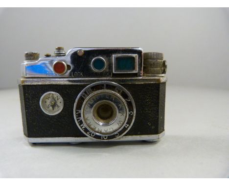 A Novelty lighter in the form of a camera - with compass and the spark creating the 'Flash'