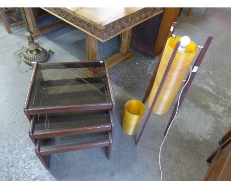 A teak and glass topped nest of tables and a teak rocket lamp, a/f