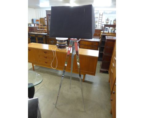 A chrome tripod standard lamp