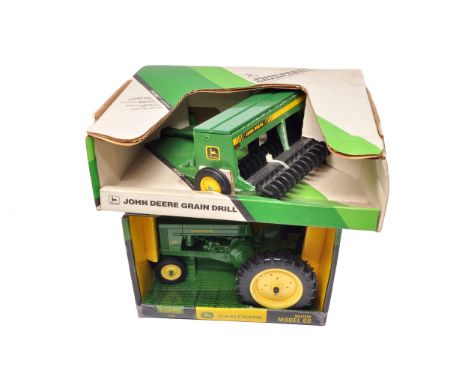 A pair of Ertl John Deere die-cast models comprising a 1/16 scale Model 60 tractor and a Grain Drill implement.Both models ap