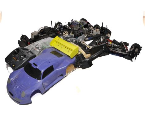 A lot of RC nitro vehicles and accessories, including four nitro car chassis, several engines, three remote controllers (incl