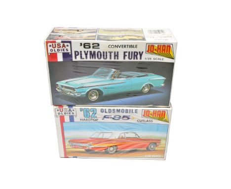 A duo of Jo-Han USA Oldies 1/25 scale plastic car kits, featuring the 1962 Plymouth Fury Convertible and the 1962 Oldsmobile 