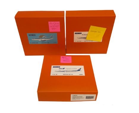 A trio of boxed die-cast aircraft models, including a Korean Air Bombardier CS300 (1:200), ANA Boeing 787-9 (1:400), and Air 