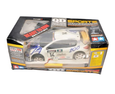 A boxed Tamiya QD Sports 1/10 scale radio-controlled car, modelled on the Peugeot 206 WRC with Clarion and ESSO livery. Untes