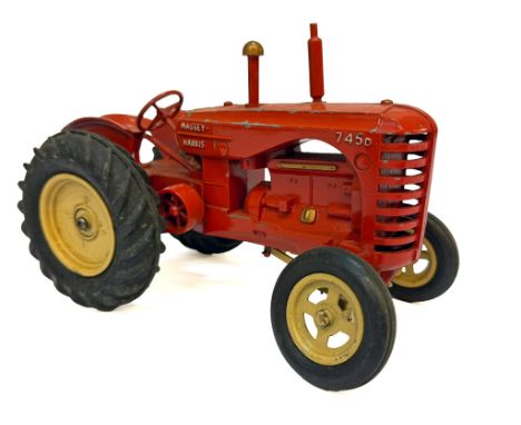 A large scale Lesney die-cast model of a Massey-Harris 745D tractor, featuring red bodywork with yellow wheels and rubber tyr