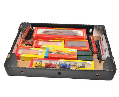 A mixed lot of Hornby 00 gauge rolling stock and accessories. Includes boxed examples such as P.W. Dept tankers, LMS brake va