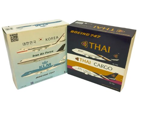 A duo of 1:200 scale die-cast Boeing 747 aircraft models, including liveries for Thai and KLM. The Thai Cargo box shows some 