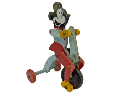 A vintage and scarce 1930's Fisher Price wooden wind-up toy depicting Mickey Mouse riding a tricycle. The figure and trike ar