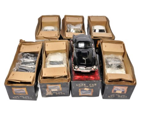 A group of eight die-cast model cars from the Luxe Car series, including several in black and cream finishes. All models appe