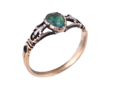 A late 18th century emerald ring, the pear cut emerald in a cut down collet closed back setting, to pierced fleur de lys shou