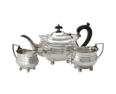 Y A silver three piece oblong baluster tea set by Alexander Clark & Co. Ltd., London 1915, with a wood oblong finial to the d