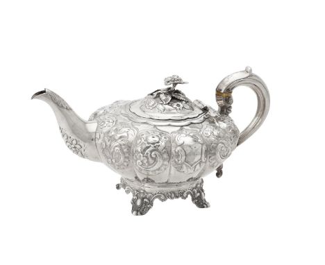 Y A Victorian silver lobed circular tea pot by William Hunter, London 1841, with a flower finial to the domed cover, a scroll