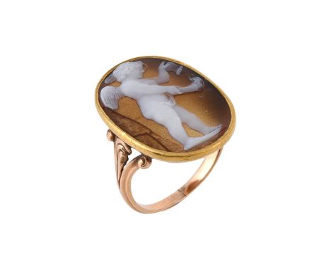 A Victorian hardstone cameo ring, the oval hardstone panel carved with Cupid holding a butterfly over a flaming torch, to tri