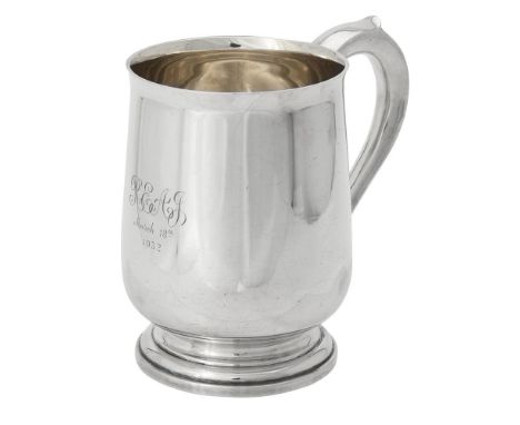 A silver baluster mug by F. C. Richards, Birmingham 1931, with a scroll handle, engraved with a presentation inscription and 