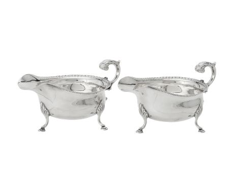 A pair of silver oval sauce boats by C. J. Vander Ltd., Sheffield 1989, with leaf capped flying scroll handles and on three s