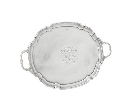 A silver twin handled shaped oval tray by James Deakin & Sons, Sheffield 1931, with twin loop handles, a raised moulded borde