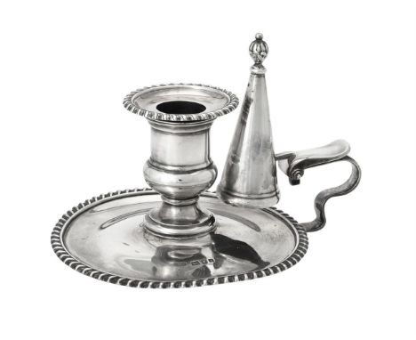 A silver chamberstick by Goldsmiths & Silversmiths Co. Ltd., London 1924, with gadrooned borders, a scroll handle and a taper