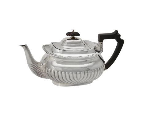 Y An Edwardian silver oblong baluster tea pot by Atkin Brothers, Sheffield 1909, with a composition finial and angular handle