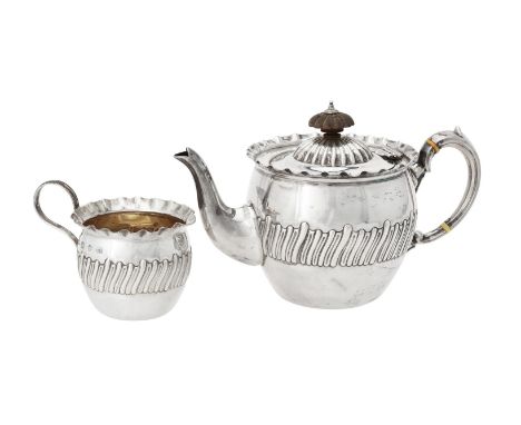 Y A Victorian silver circular tea pot and cream jug, maker's mark T.W, Birmingham 1893, the tea pot with a wooden lobed circu