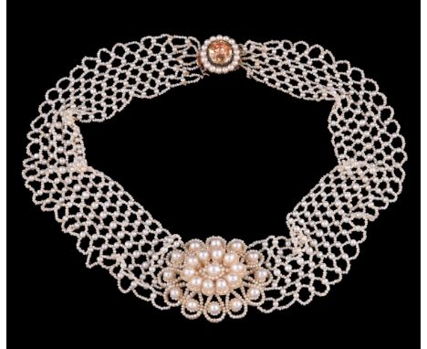 Y A late George III seed pearl and topaz necklace, circa 1810, the central pearl and seed pearl flower head, mounted with mot