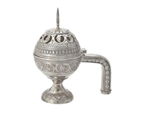 An Omani silver coloured incense burner, 20th century, with a cone finial, chased and pierced with decorative bands, a handle
