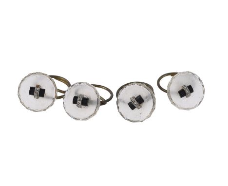 A set of four French 1930s rock crystal, onyx and diamond buttons, the circular rock crystal backs with facetted edges, to an