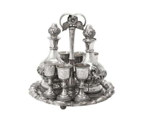 An Austrian silver liquor stand, Vienna 1845, with a loop handle, a shaped border, chased and engraved with floral sprays, on