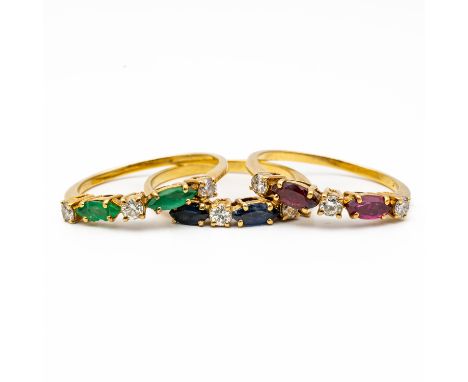 THREE GOLD, DIAMOND AND COLOURED GEMSTONE STACKING RINGS (3)Comprising; an emerald and diamond five stone ring, mounted with 