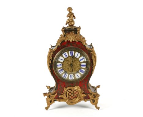 A VICTORIAN TORTOISESHELL AND BRASS 'BOULLE' MARQUETRY MANTEL CLOCKLate 19th Century 
The case surmounted by a seated cherub 
