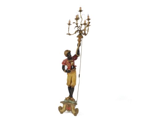 A POLYCHROME PAINTED FIGURAL CANDELABRAOf a standing moor, on scroll base, 168cm high