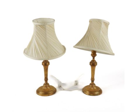 A PAIR OF LOUIS XVI STYLE GILT-METAL CANDLESTICK TABLE LAMPS (2)Early 20th Century and later adapted 
Weighted undersides, 47