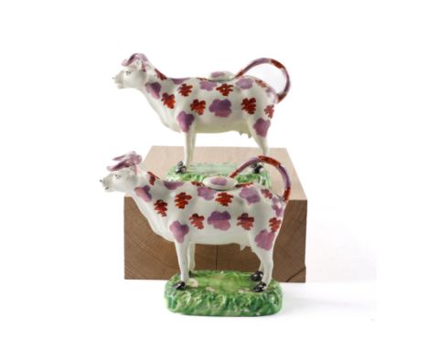 A PAIR OF CAMBRIAN POTTERY COW CREAMERS AND COVERS (4)Circa 1830 Each  standing four square, decorated in iron-red and pink l