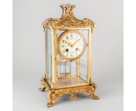 A FRENCH GILT-SPELTER AND BRASS FOUR-GLASS MANTEL CLOCKCirca 1910
The case with a swept foliate-mounted pediment, with four b