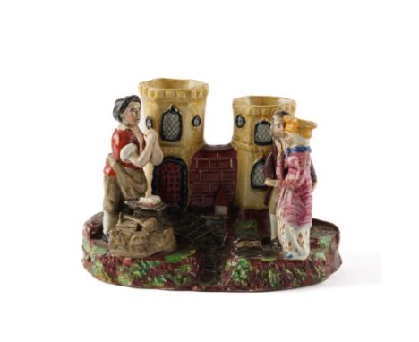 A STAFFORDSHIRE PEARLWARE GRETNA GREEN SPILL VASE GROUPCirca 1830 Modelled with the blacksmith and couple standing before a c