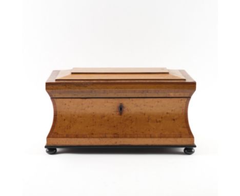 A WILLIAM IV BIRDSEYE MAPLE SARCOPHAGUS FORM TEA CADDYOn ebonised bun feet, 36cm wide; 19cm deep; 18cm high