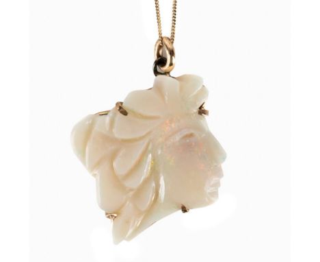 A CARVED OPAL PENDANT NECKLACEThe opal motif of a face looking right, measuring 20mm x 20mm, in unmarked gold, on a 9ct trace